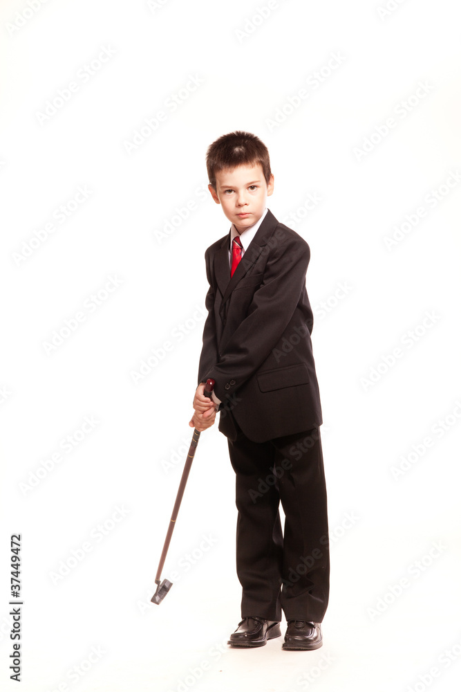 Boy in official dresscode with a golf club Boy in official dresscode with a golf club