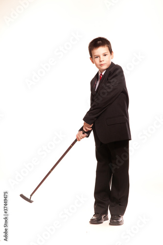 Boy in official dresscode with a golf club