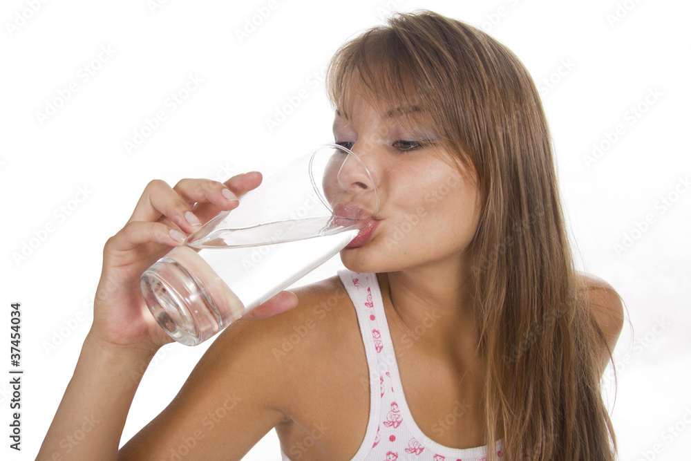 Young woman holds glass and girl drinks water. Isolated backgrou Young woman holds glass and girl drinks water. Isolated backgrou
