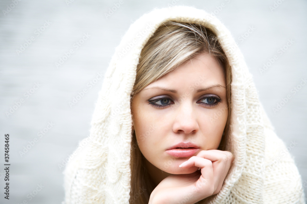 Obraz premium The thoughtful girl in knitted dress