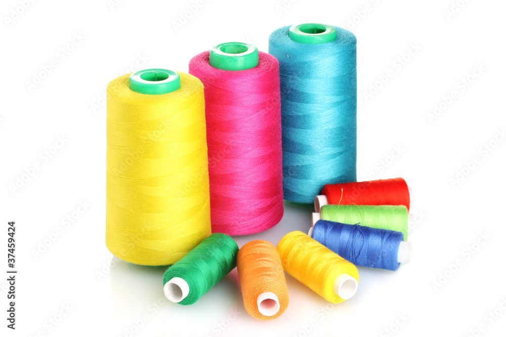 Many-coloured bobbins of thread isolated on white Many-coloured bobbins of thread isolated on white