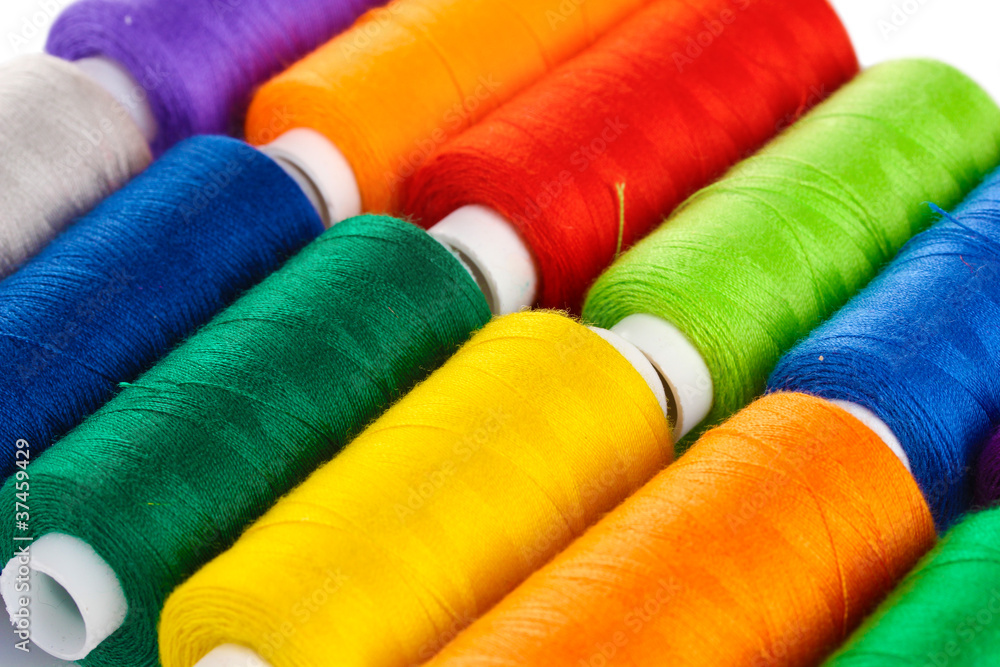 Many-coloured bobbins of thread closeup Many-coloured bobbins of thread closeup