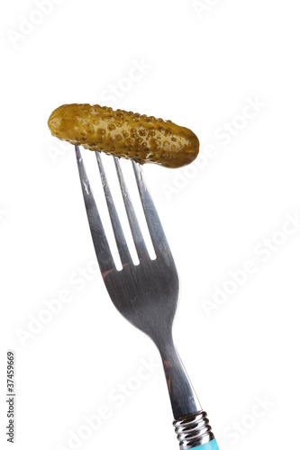 Marinated cucumber on fork isolated on white