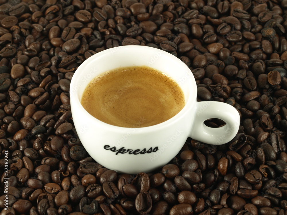 Espresso morning coffee with beans as a background Espresso morning coffee with beans as a background