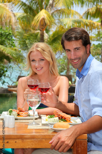 Young couple enjoying lunch in resort restaurant