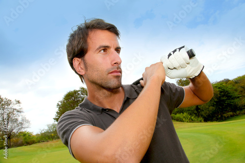 Portrait of man holding golf club