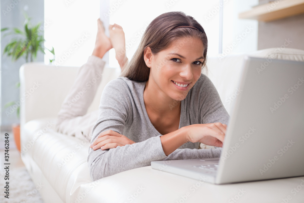 Woman on the sofa reading e-mail Woman on the sofa reading e-mail
