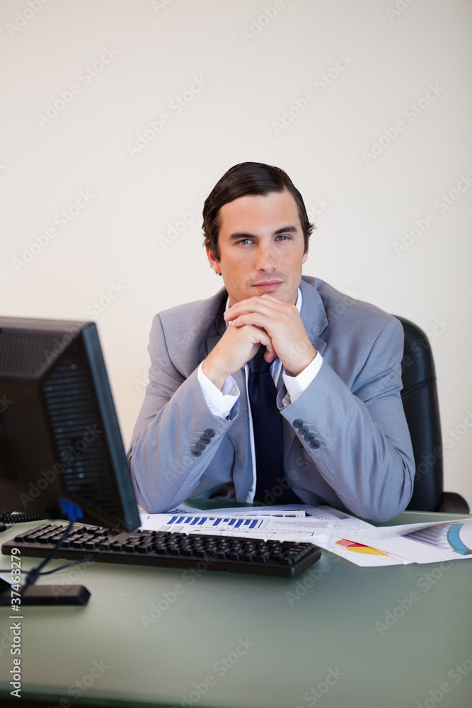 Businessman sitting behind his desk Businessman sitting behind his desk