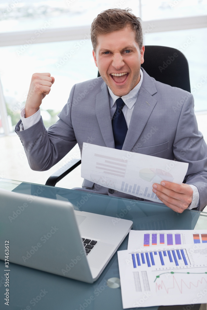 Businessman celebrating market research results Businessman celebrating market research results