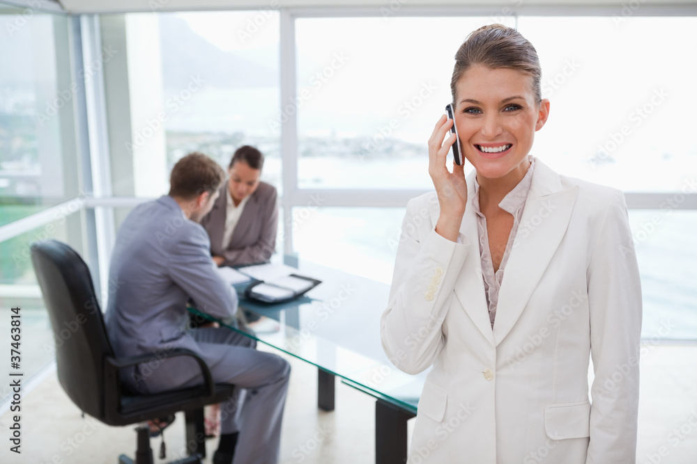 Smiling marketing manager on the phone Smiling marketing manager on the phone