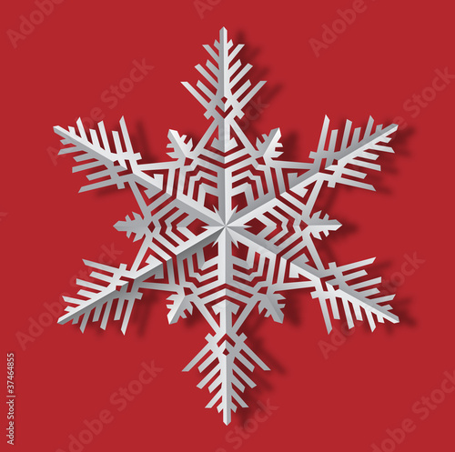Vector image of the snowflake with the shadow made of cut paper isolated on the red background.