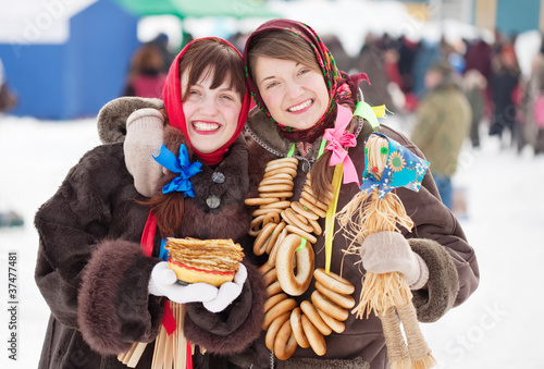 girls with pancake and round cracknel during  Shrovetide photo