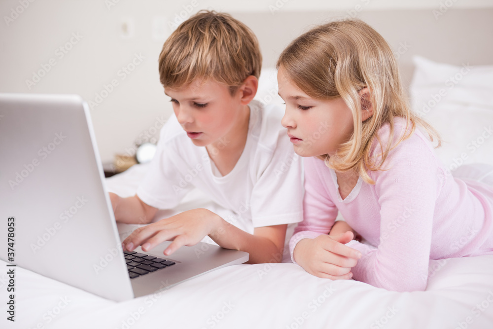Cute children using a laptop Cute children using a laptop