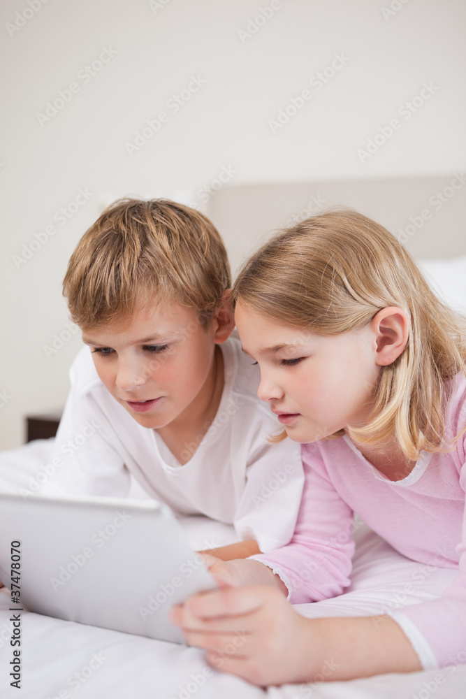 Portrait of cute children using a tablet computer Portrait of cute children using a tablet computer