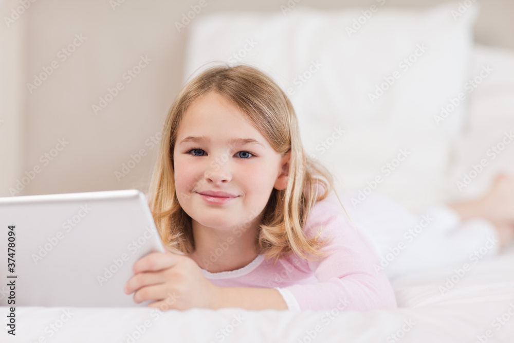 Cute little girl using a tablet computer Cute little girl using a tablet computer