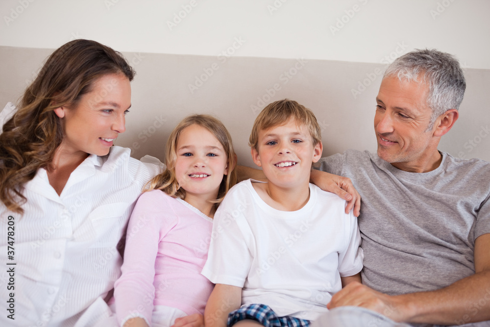 Good looking family lying on a bed