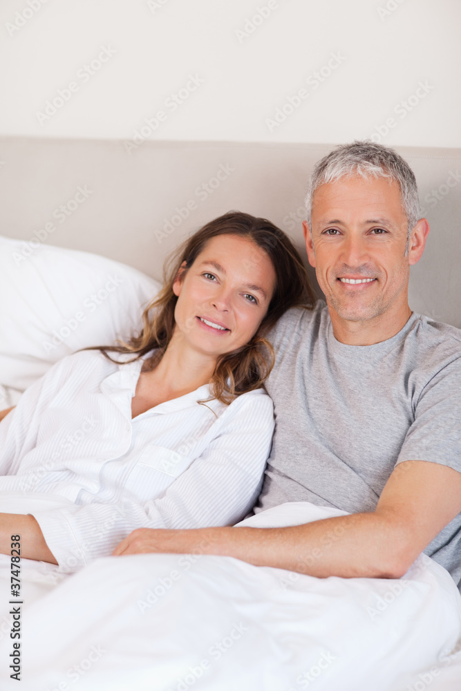 Portrait of a couple lying on a bed Portrait of a couple lying on a bed