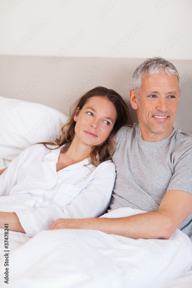 Portrait of a happy couple lying on a bed Portrait of a happy couple lying on a bed