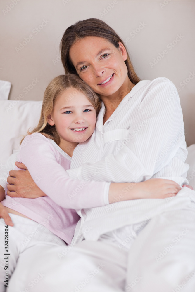 Portrait of a mother and her daughter hugging Portrait of a mother and her daughter hugging