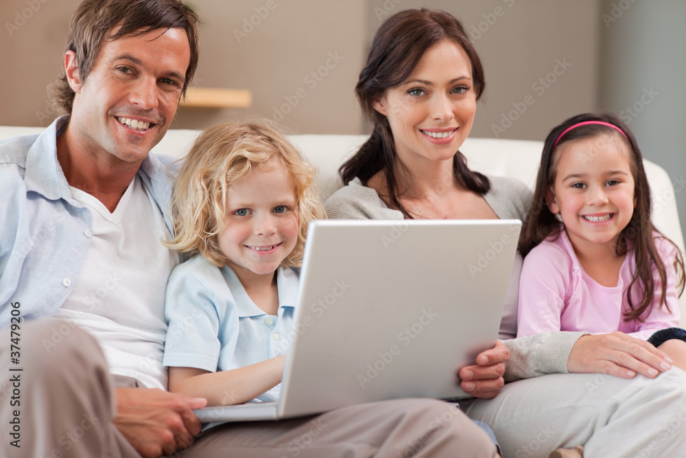 Calm family using a notebook Calm family using a notebook