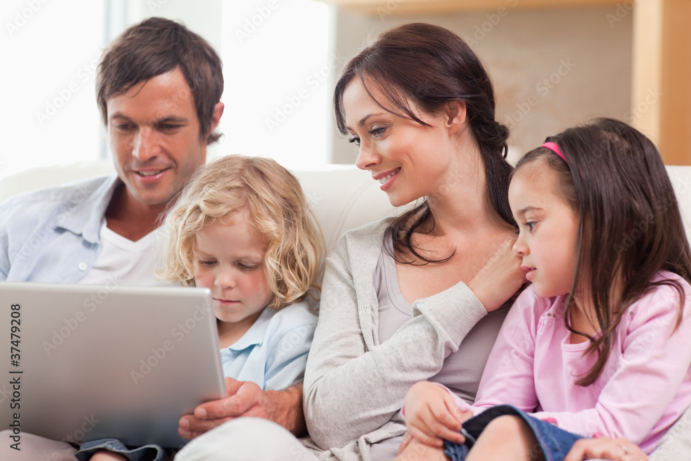 Serene family using a notebook Serene family using a notebook
