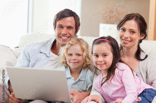 Delighted family using a laptop © WavebreakmediaMicro