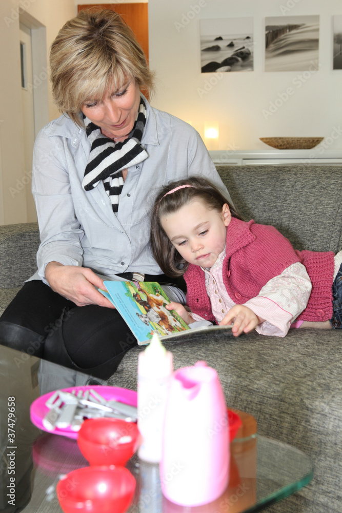 Woman and little girl reading a book