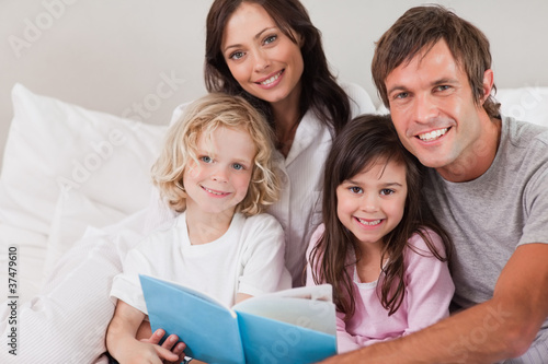 Happy family reading a book