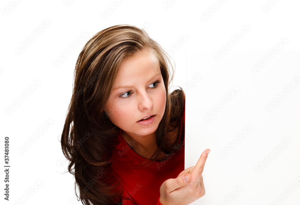 Young attractive girl behind empty board on white background Young attractive girl behind empty board on white background