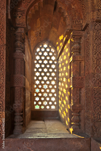 Photography Qutb Minar, Delhi, carvings in the sandstone of a window gives a