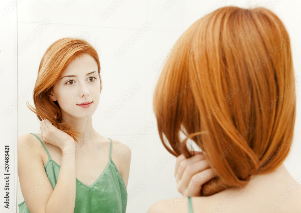 Beautiful redhead young woman with fresh skin of face in bathroo Beautiful redhead young woman with fresh skin of face in bathroo