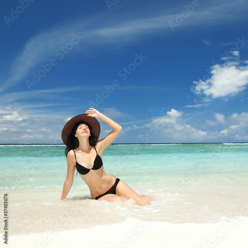 Happy fashion woman on the beach