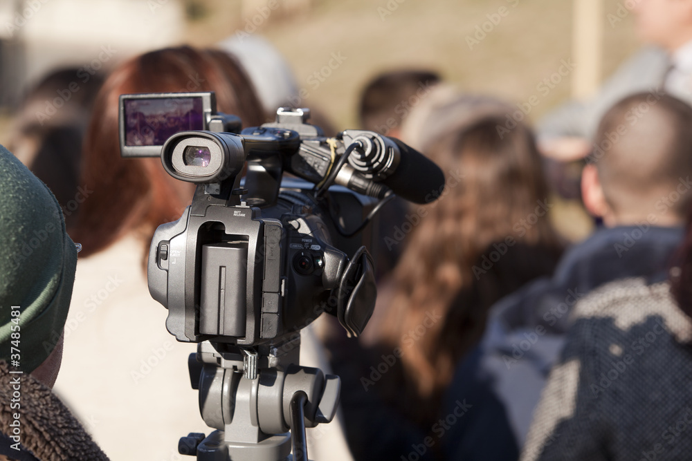 covering an event with a video camera covering an event with a video camera