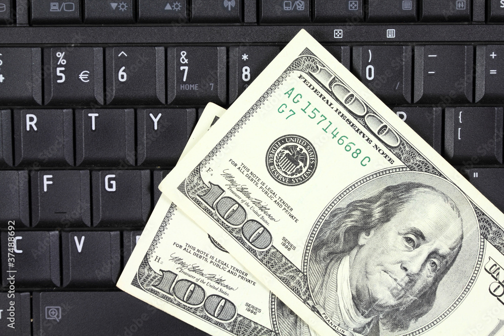 Online business - US dollars and laptop keyboard Online business - US dollars and laptop keyboard