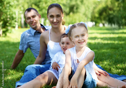 Family with two children in the summer park