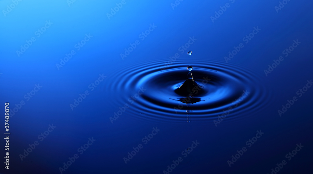 Drop of water falling into the water Drop of water falling into the water