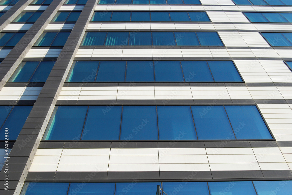 Office building wall down-up view with blue glass windows Office building wall down-up view with blue glass windows