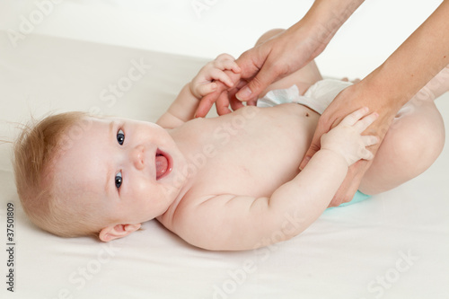 mother massaging her baby boy