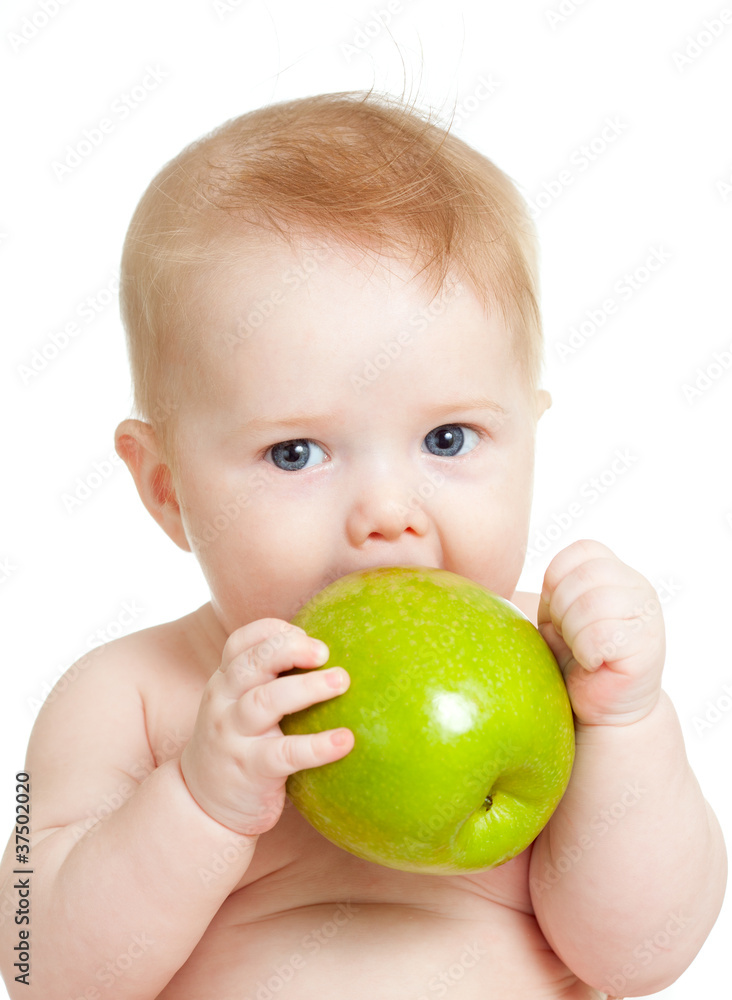 Baby boy holding and eating green apple, isolated on white Baby boy holding and eating green apple, isolated on white
