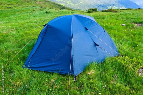 touristic tent among a green fields