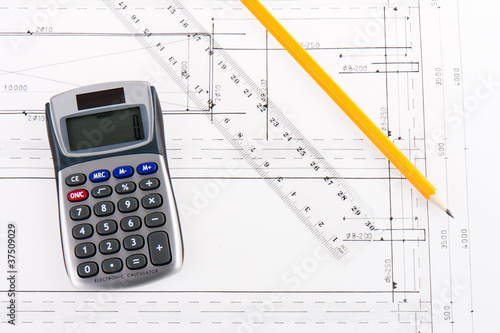 Building plan with calculator, ruler and pencil