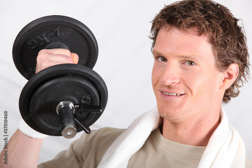Man working out with a 2kg dumbbell Man working out with a 2kg dumbbell