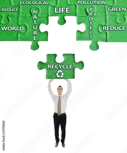 Recycle word on puzzle in man hands photo