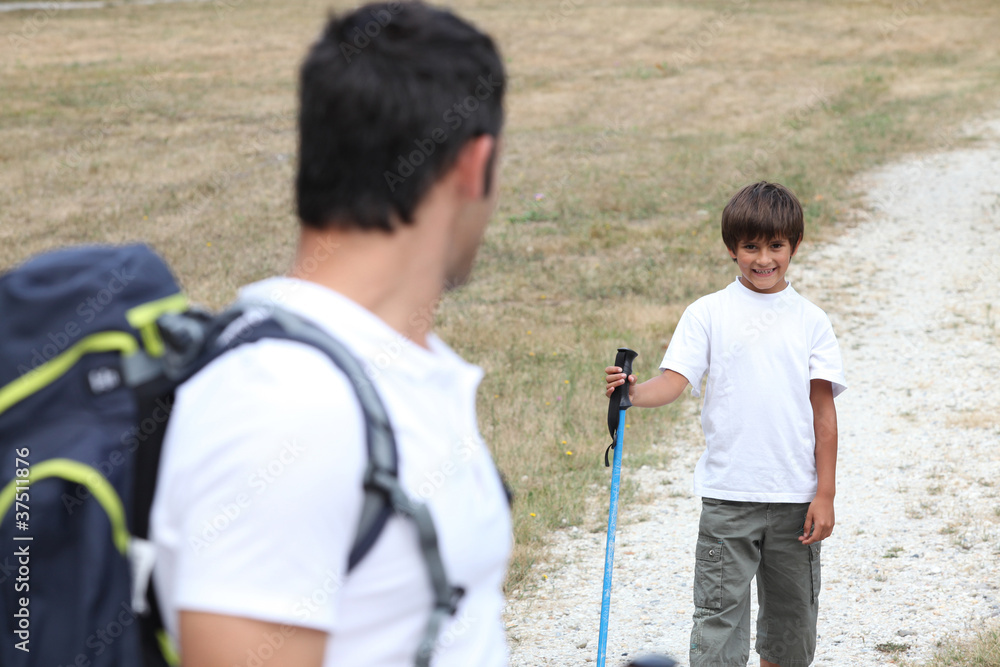 Naklejka premium Man and little boy hiking