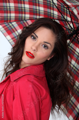 A cute brunette model with an umbrella.