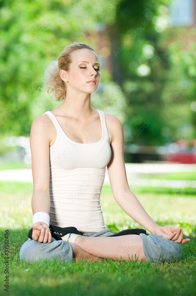 Young woman doing yoga exercise