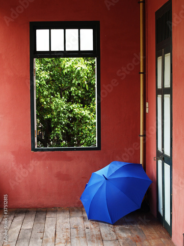 Blue Umbrella and Red Wall