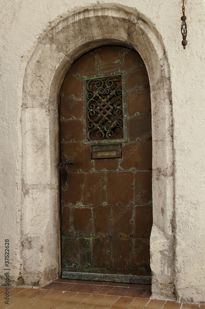 Old oxidated copper entrance door with verdigris