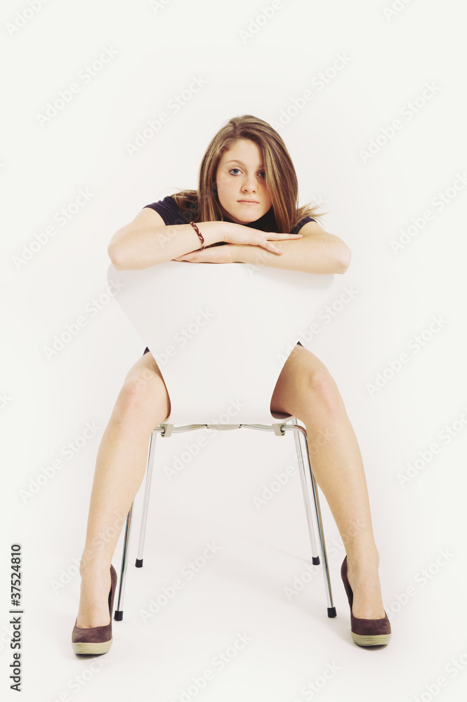 Beautiful blonde caucasian girl with chair.