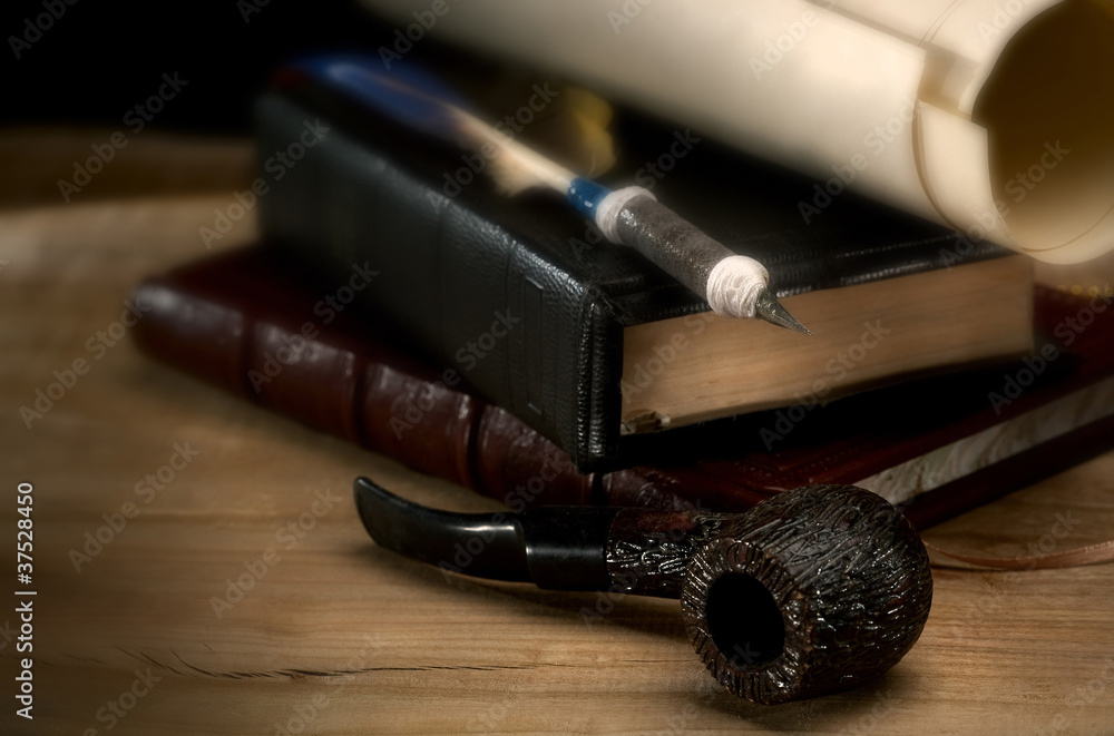 Retro still life with writing tools, books and smoking pipe